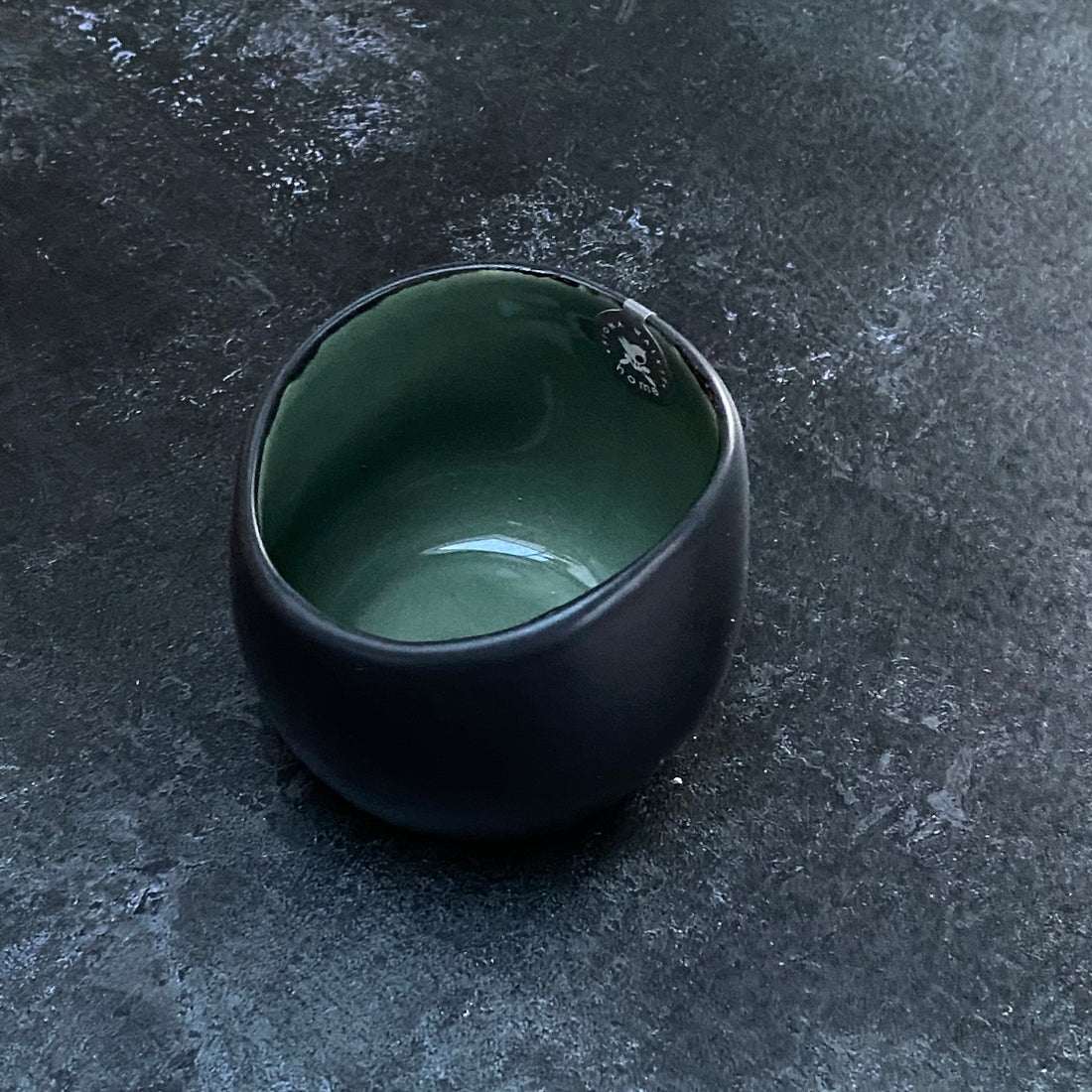 BLACK STONEWARE TEALIGHT WITH GREEN GLAZE INSIDE